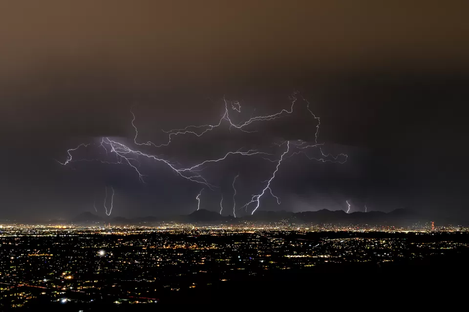 Lightning strikes over Tucson, Arizona at night during monsoon storm
